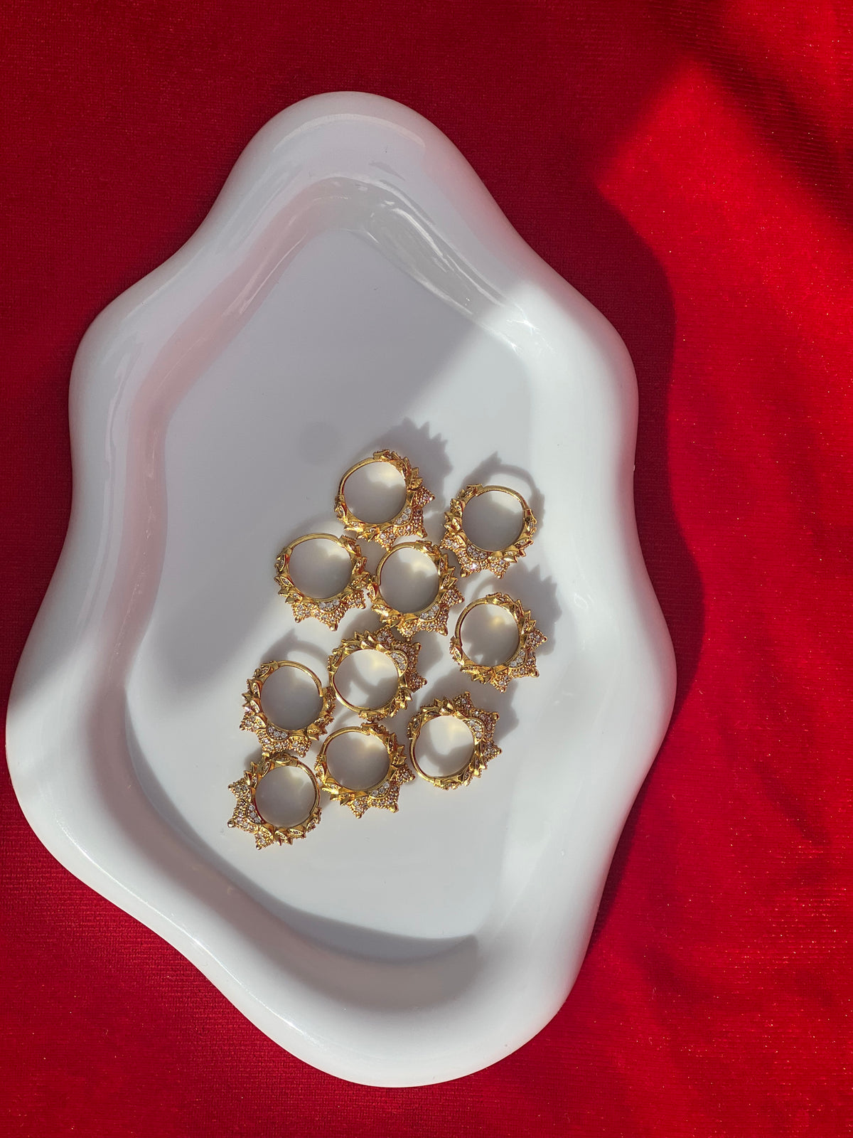 Zari Marwari gold plated rings pair on white dish