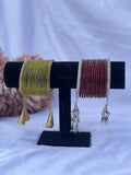 Chura bangles set in olive green with gold tassels and maroon with silver tassels